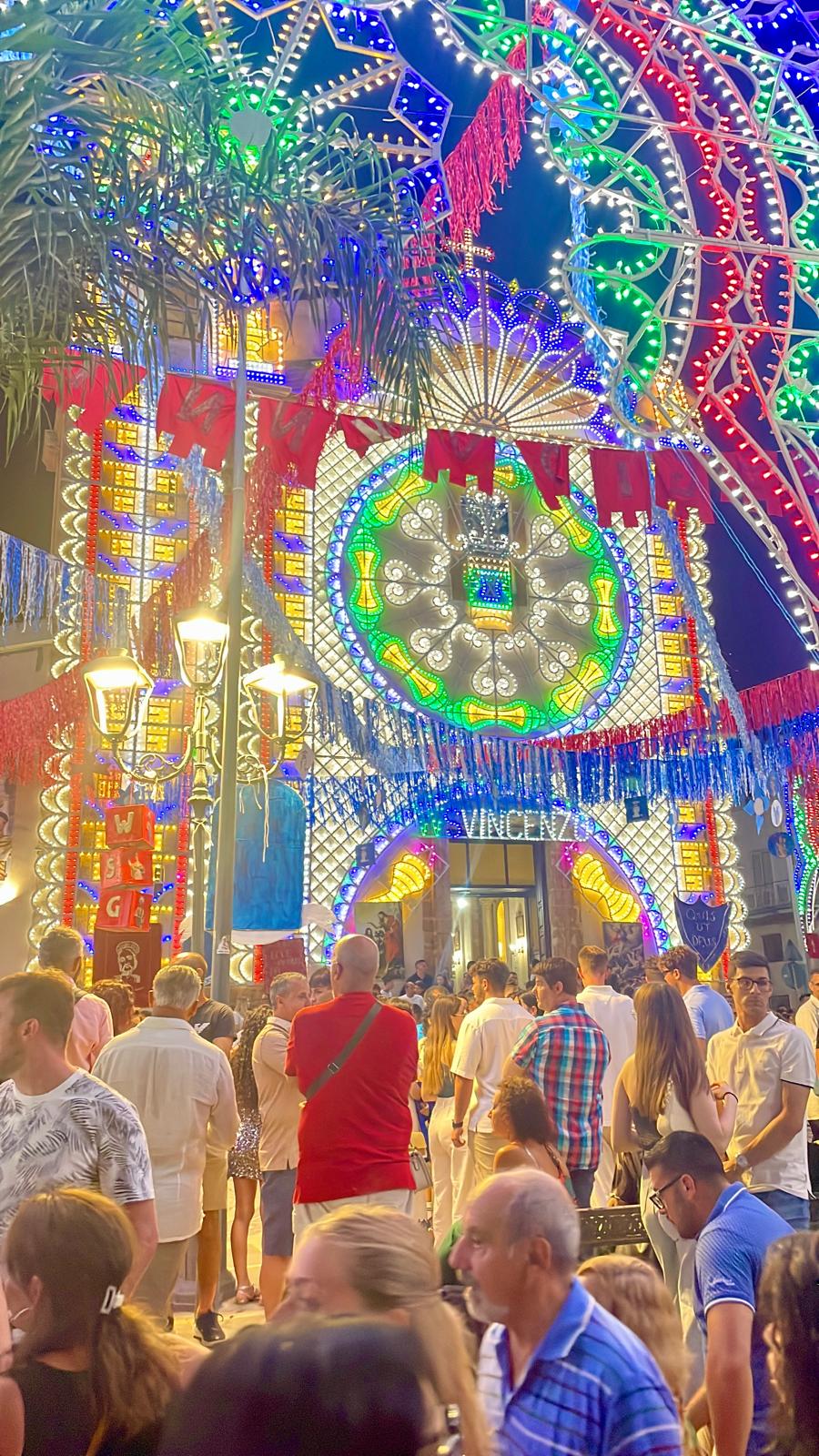 Crowd gathered beneath the lights of a Sicilian festa